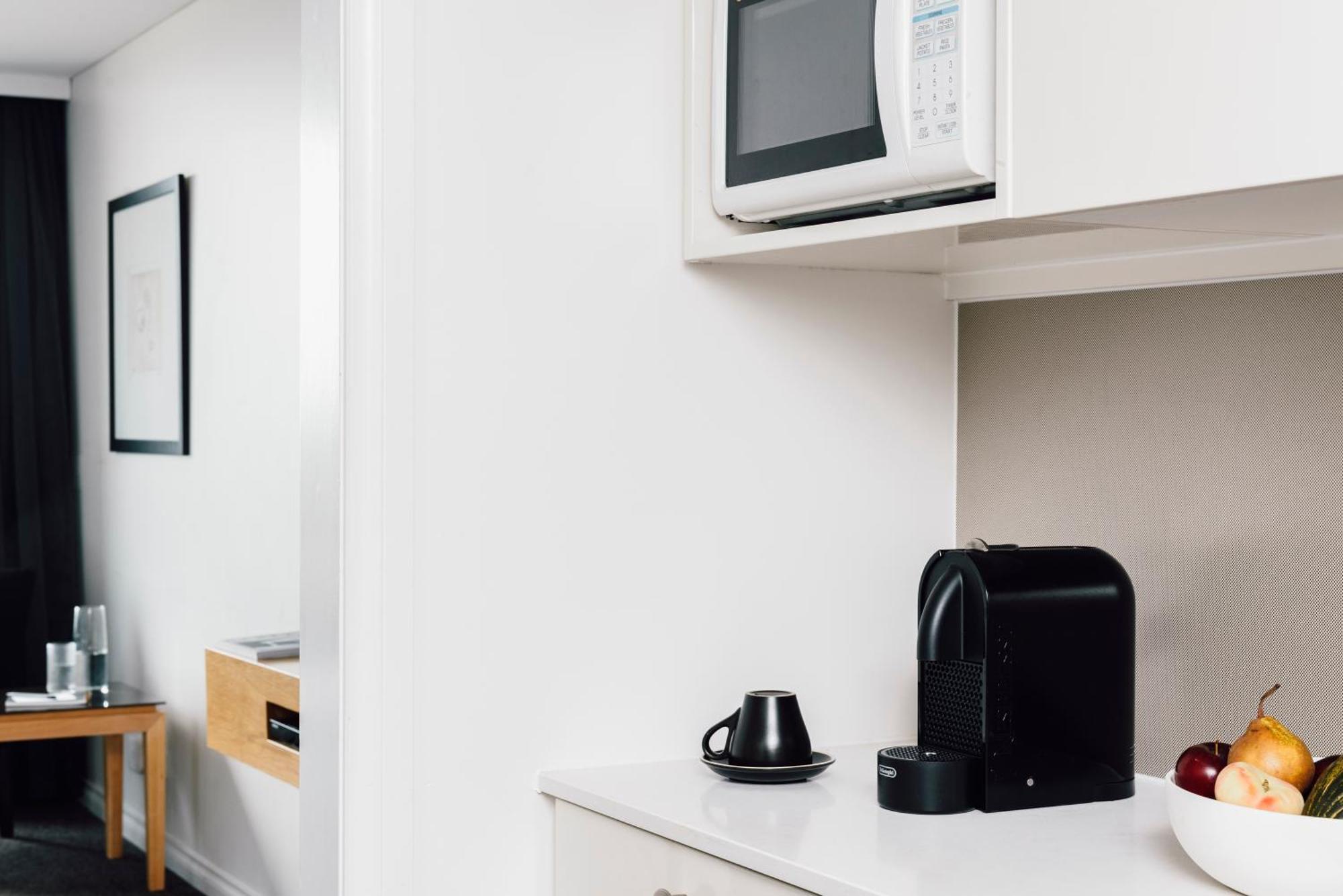 Quay West Suites Melbourne Exterior photo A Nespresso coffee machine in a hotel room
